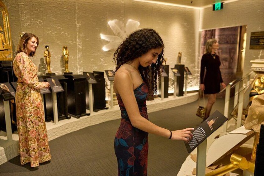 A museum interior with exhibits and visitors. 4