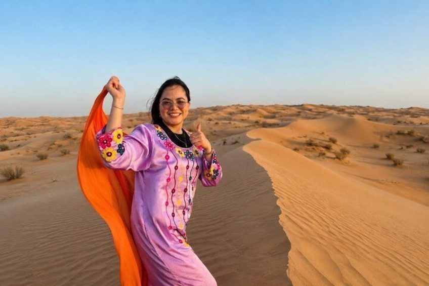 A person in a desert landscape with sand dunes and a clear sky. 5