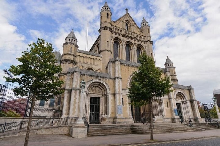 A historic building with arched windows and a central tower. 4