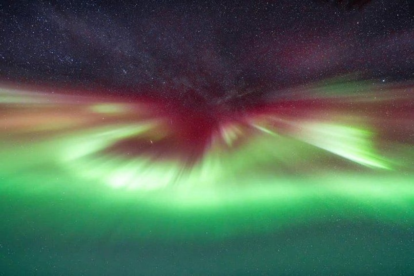 A night sky with a green aurora display. 2