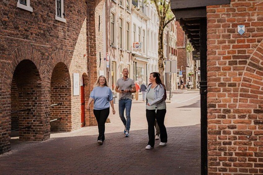 A brick alleyway with pedestrians walking. 4