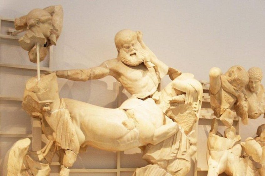 Una escultura de mármol de un hombre montando un caballo, con otras figuras de fondo. 5