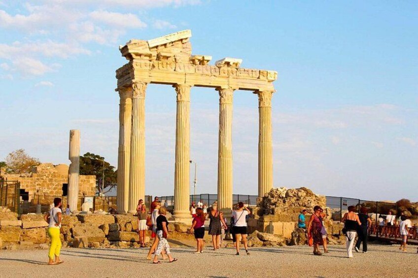 Ancient Greek columns, ruins, and tourists. 1