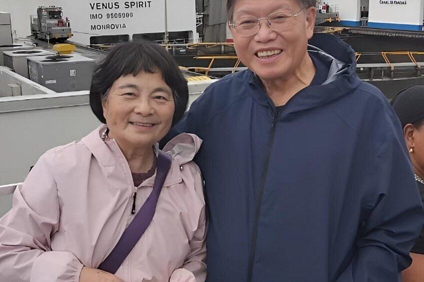 Two people standing on a rooftop with industrial equipment in the background. 3