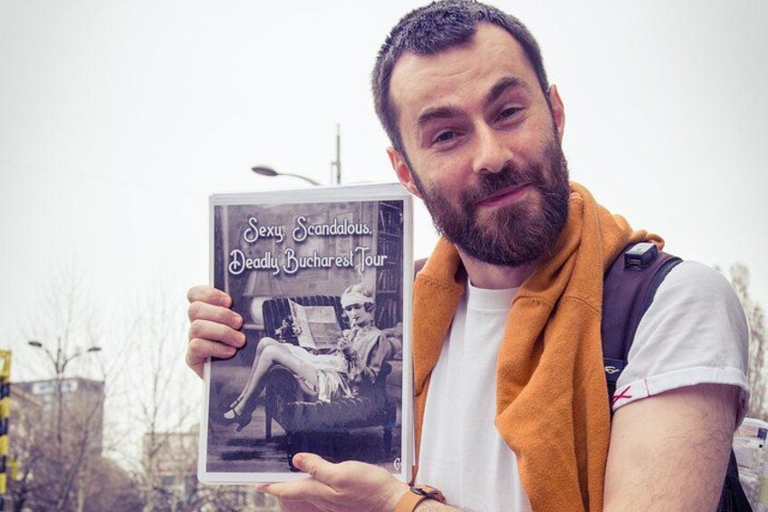 A person holding a book titled 'Sexy Scandalous, Deadly Bucharest Tour.' 2