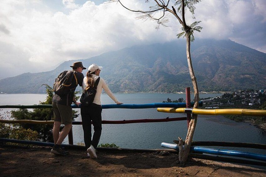 Two hikers overlooking a lake with mountains in the background. 2