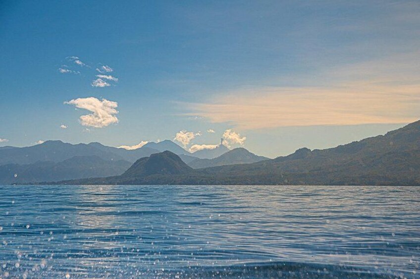 A calm lake with mountains in the background under a clear sky. 5
