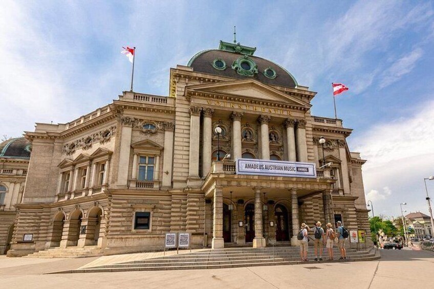 A large, historic building with classical architecture, featuring columns and a prominent dome. 4