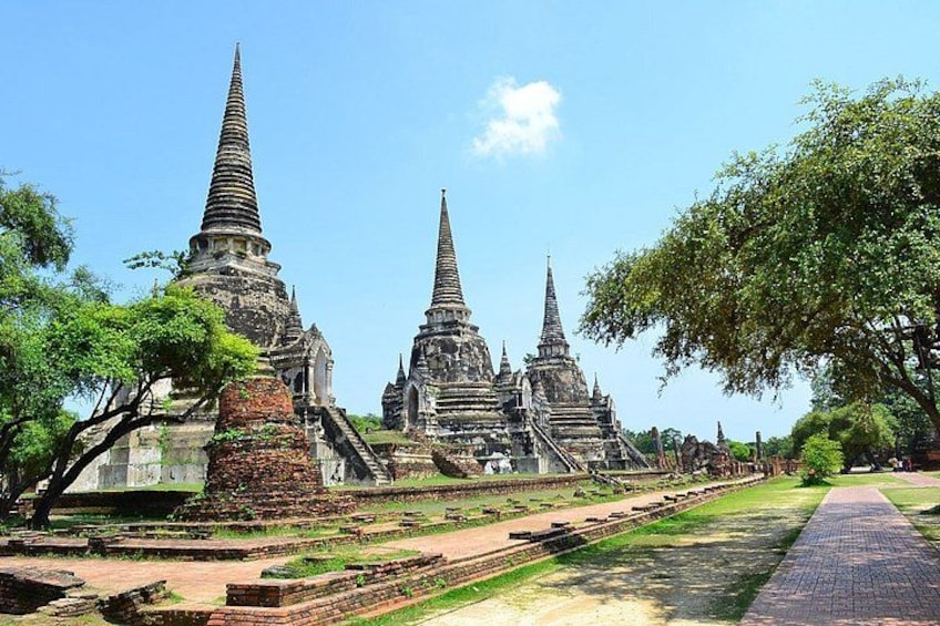 Ancient temple structures with multiple spires, surrounded by greenery and pathways. 5