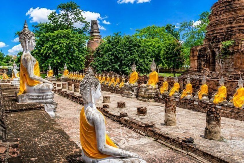 A row of seated Buddha statues in a temple courtyard. 3