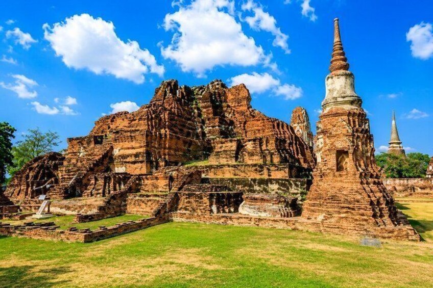 Ancient ruins with a large stupa and a smaller temple structure. 2