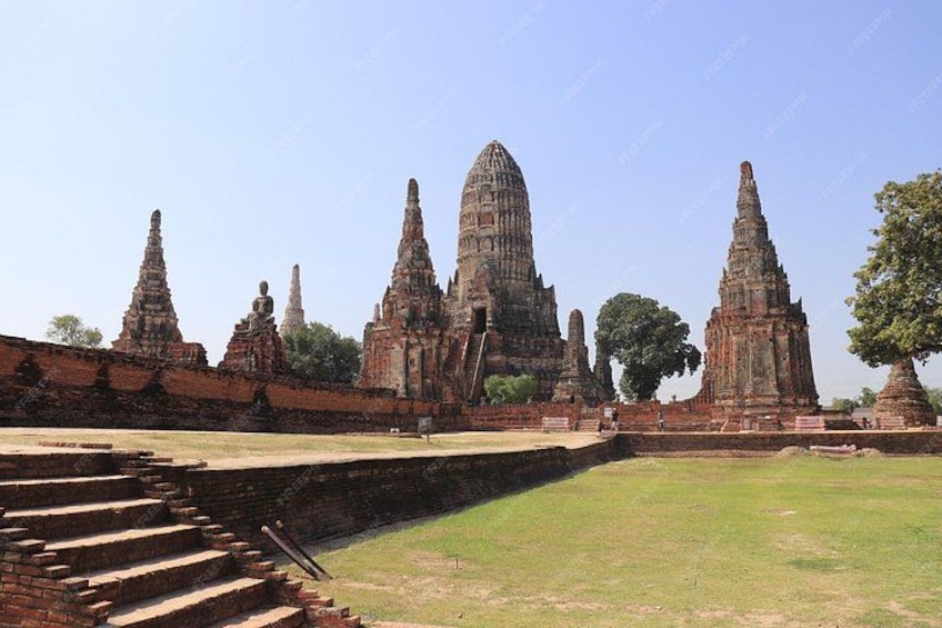 Ancient temple ruins with multiple tiered structures and a staircase leading up to the entrance. 2