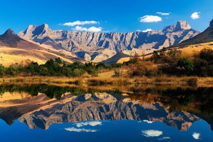 A mountain range with a clear reflection in a calm body of water. 5