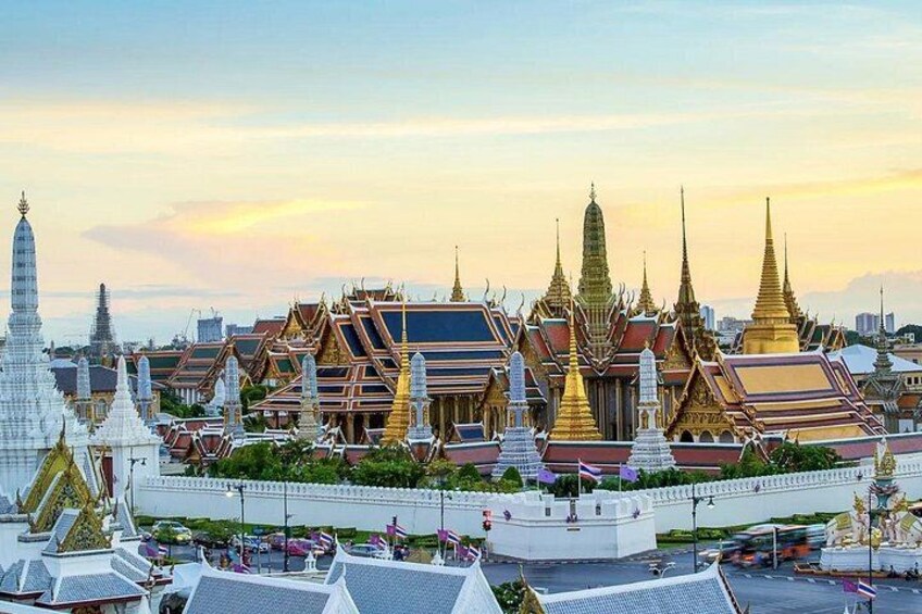 A temple complex with ornate golden spires and traditional Thai architecture. 5