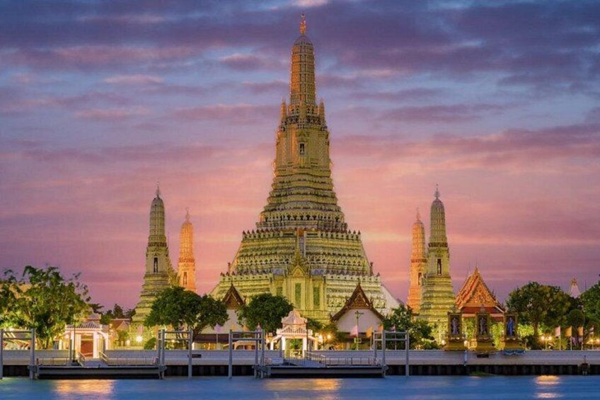 A large temple complex with multiple towers and a central spire, surrounded by water and trees. 4