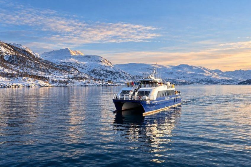 A boat on a calm lake with snow-covered mountains in the background. 4