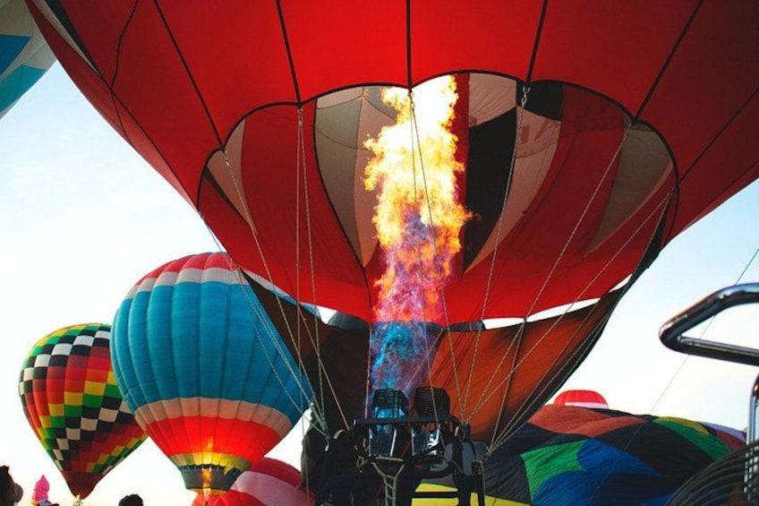 A hot air balloon with flames and smoke. 4