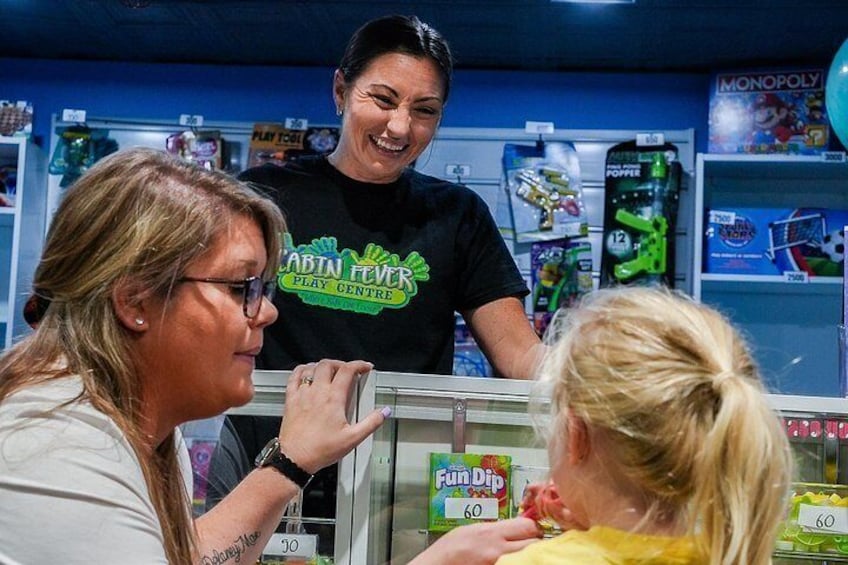 A play center with a woman in a black shirt and a child in a yellow shirt. 2