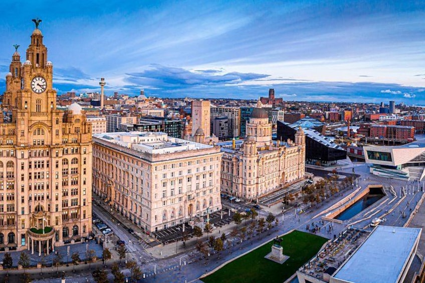 A cityscape with historic buildings, a large square, and a modern structure. 1