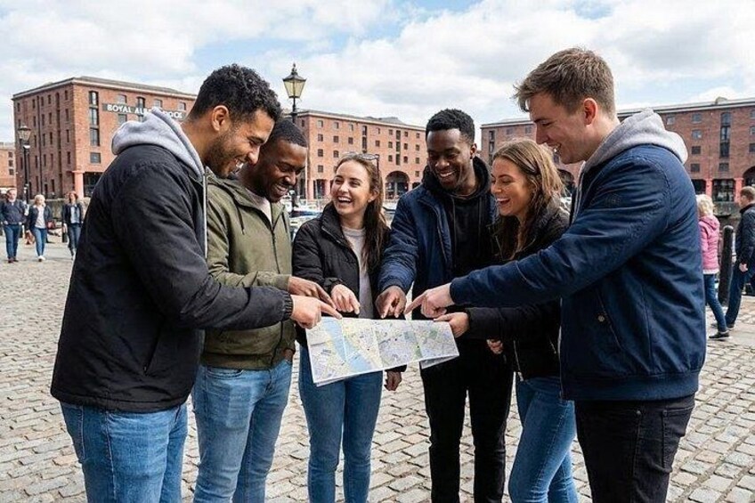 A group of people examining a map outdoors. 3