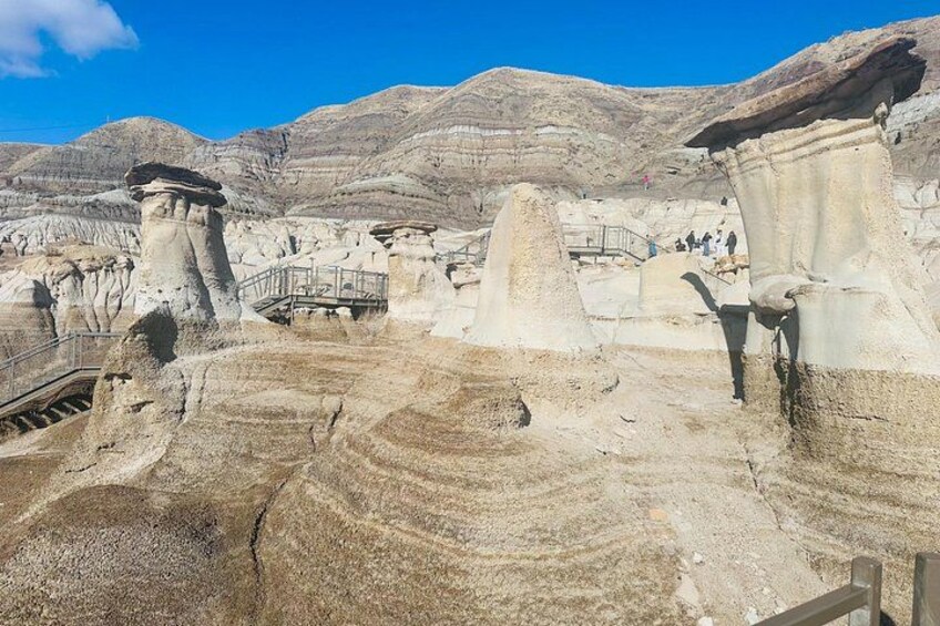 A rocky landscape with a bridge, a staircase, and a large rock formation. 5