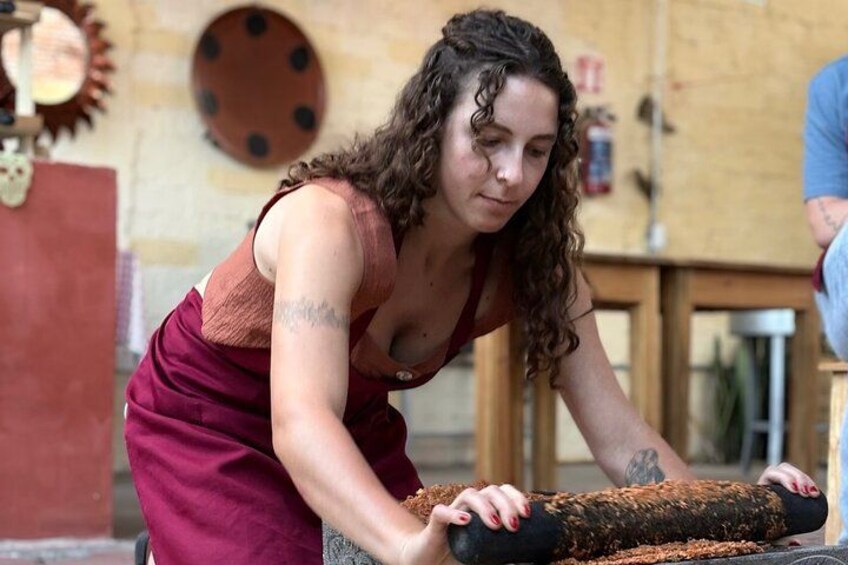 A person working with a large log, possibly in a workshop or outdoor setting. 5