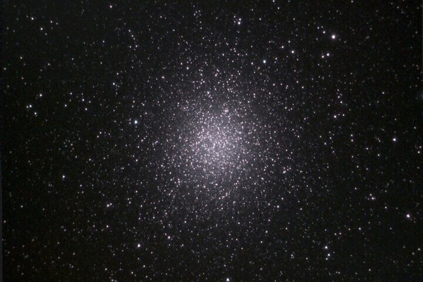 A starry night sky with a dense cluster of stars. 4