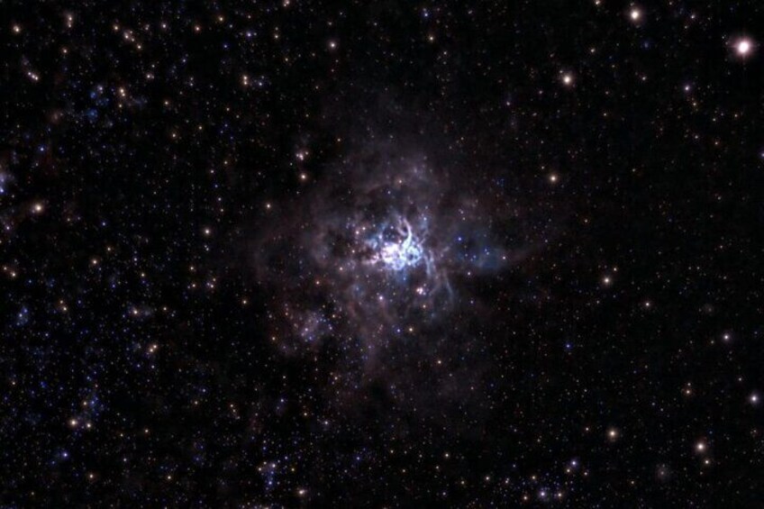 A dense star field with a bright nebula and a cluster of stars. 5