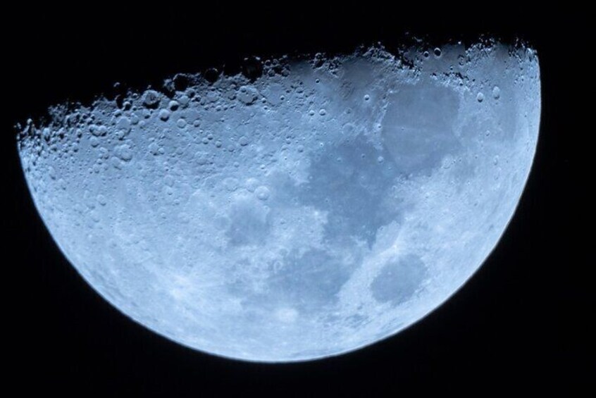 A detailed view of the moon's surface with visible craters and lunar maria. 3