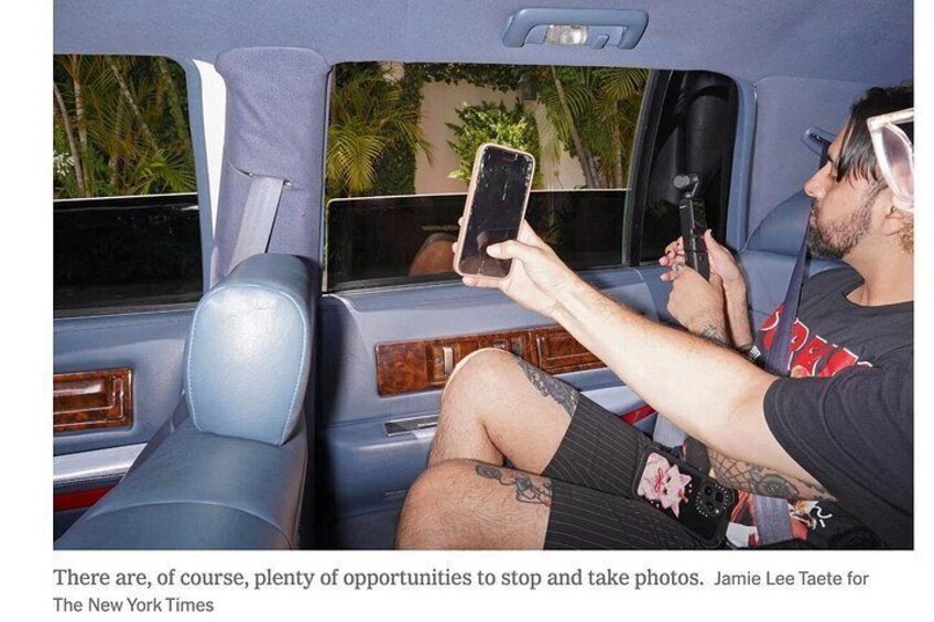 A person sitting in a car, holding a smartphone. 4
