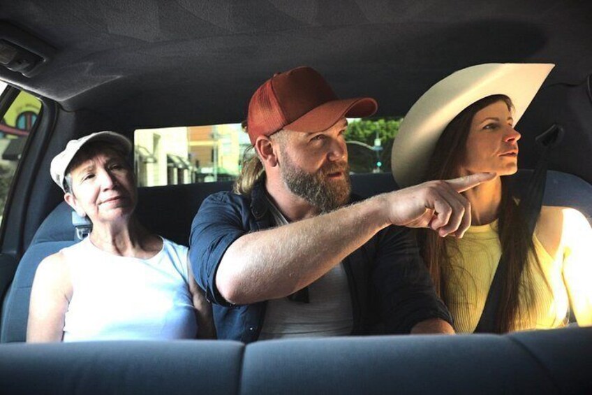 A car interior with three people. 1