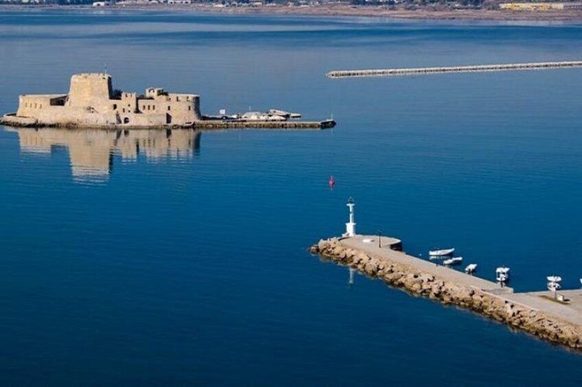 A coastal fortification, a lighthouse, and a pier extending into the water. 4