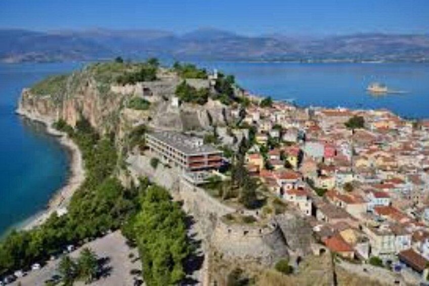 A coastal town with a cliffside, a beach, and a body of water. 2
