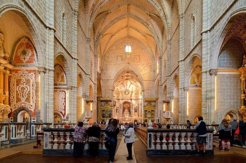 Ein Dominneres mit hohen Gewölbedecken, aufwendigen Säulen und einem zentralen Altar. 2
