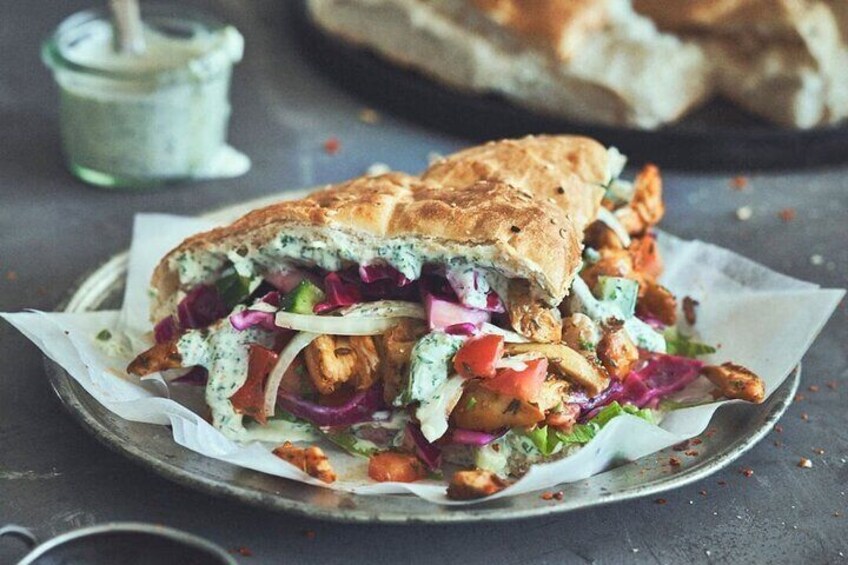 A sandwich with a crispy exterior, filled with vegetables and a creamy sauce. 1