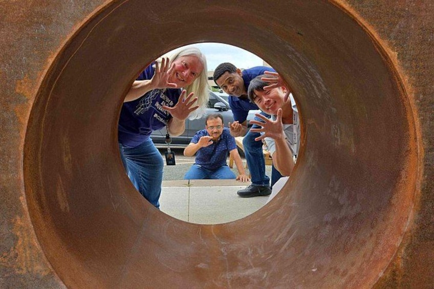 A large metal pipe with people inside. 2