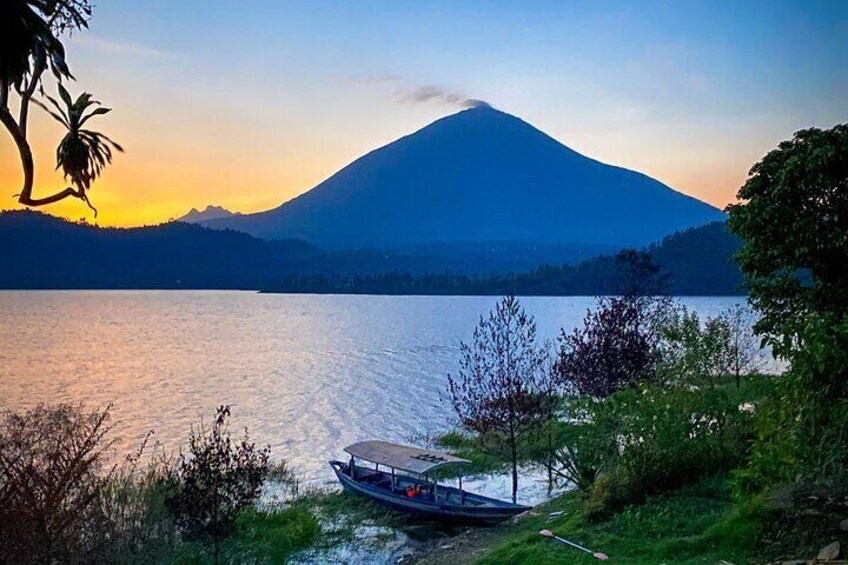 A boat on a calm lake with a mountain in the background. 5