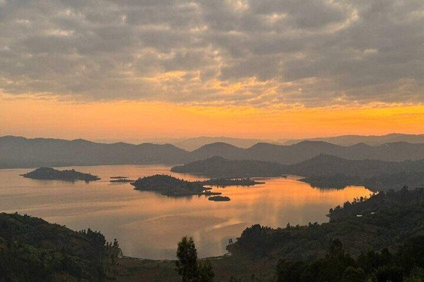 A lake surrounded by hills during sunset. 1