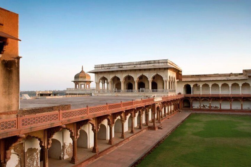 A historic building with arched walkways and a dome. 2