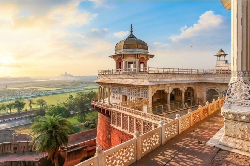 A historical building with a dome, a bridge, and a view of a river and greenery. 3