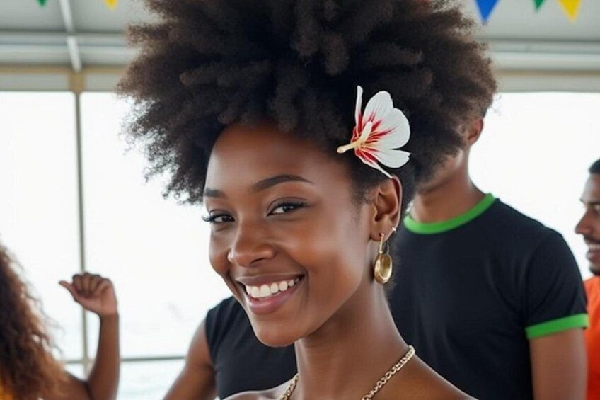 A person with a flower accessory, wearing a black top with green trim, and a gold necklace. 3