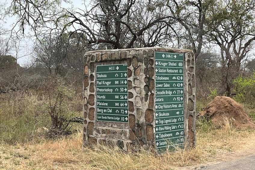A stone signpost with directional information for various destinations. 5