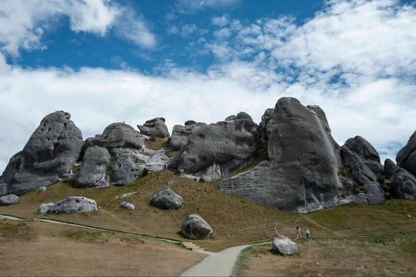 A landscape with large rock formations and a path. 3