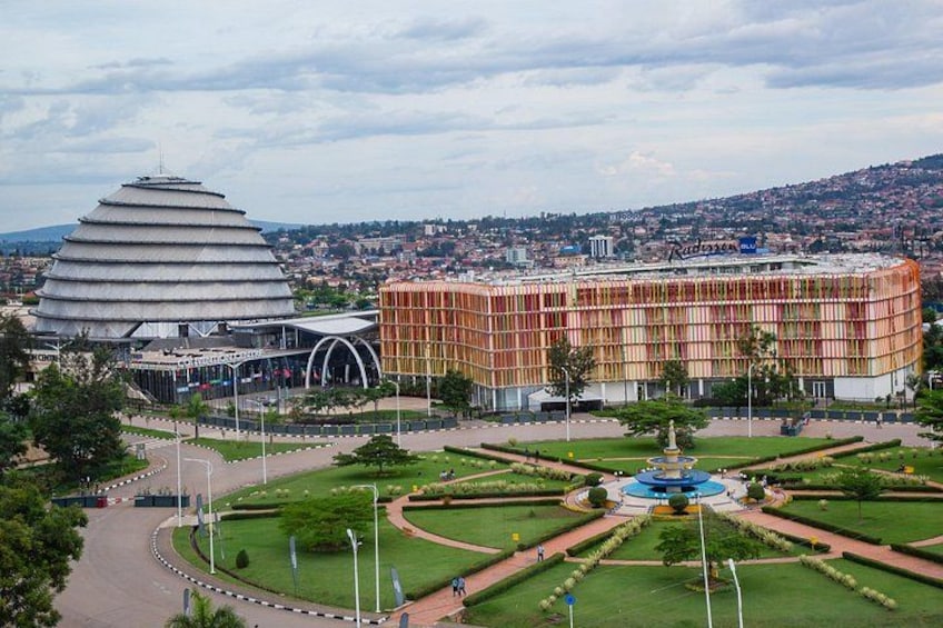 A cityscape with a distinctive modern building with a circular design and a traditional building with a striped facade. 1
