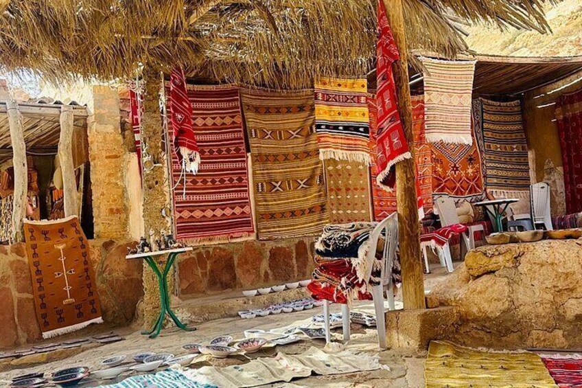 Un mercado tradicional con textiles tejidos y arquitectura de piedra. 3