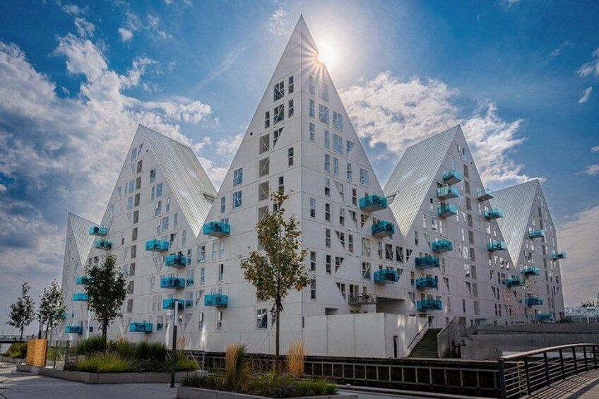 A modern building with triangular shapes and balconies. 2
