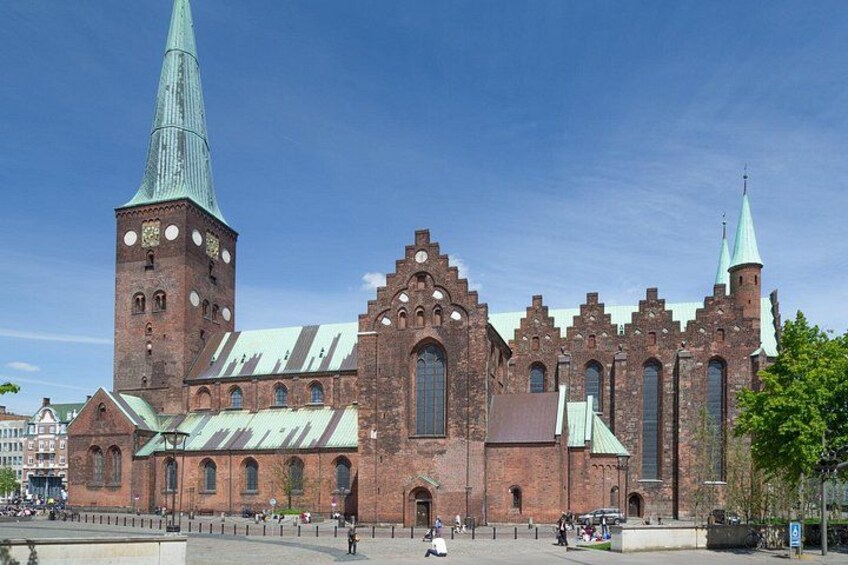 A historic church with a tall spire and a clock tower. 3