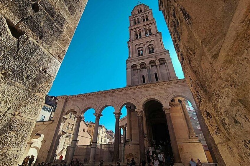 A historic building with a prominent tower and arches. 4
