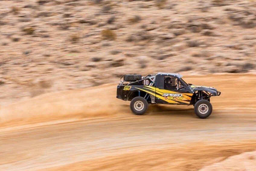 A vehicle with 'SPEED VEGA' and '10' decals driving on a dirt road. 3