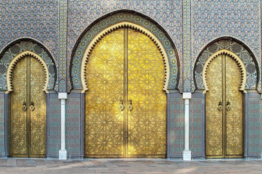 A large ornate gate with intricate patterns and a golden finish. 3